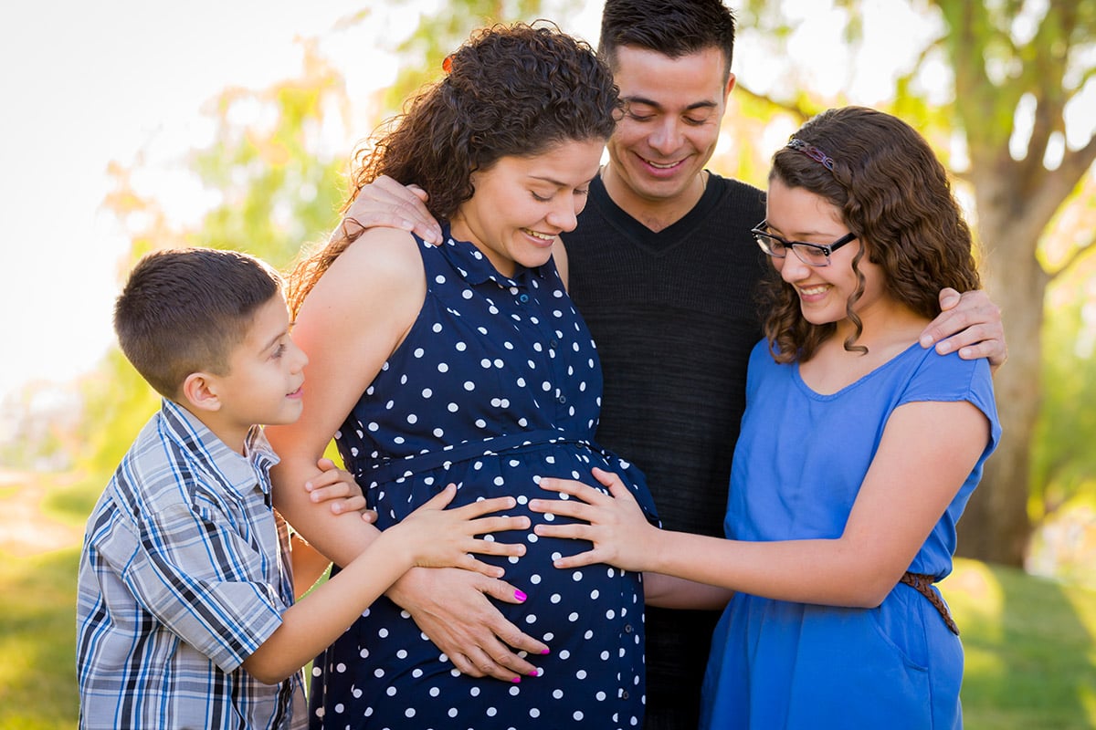 Family outside with pregnant mom